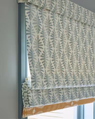Automatic roman blinds installed in a Dubai living room — cozy luxury finish