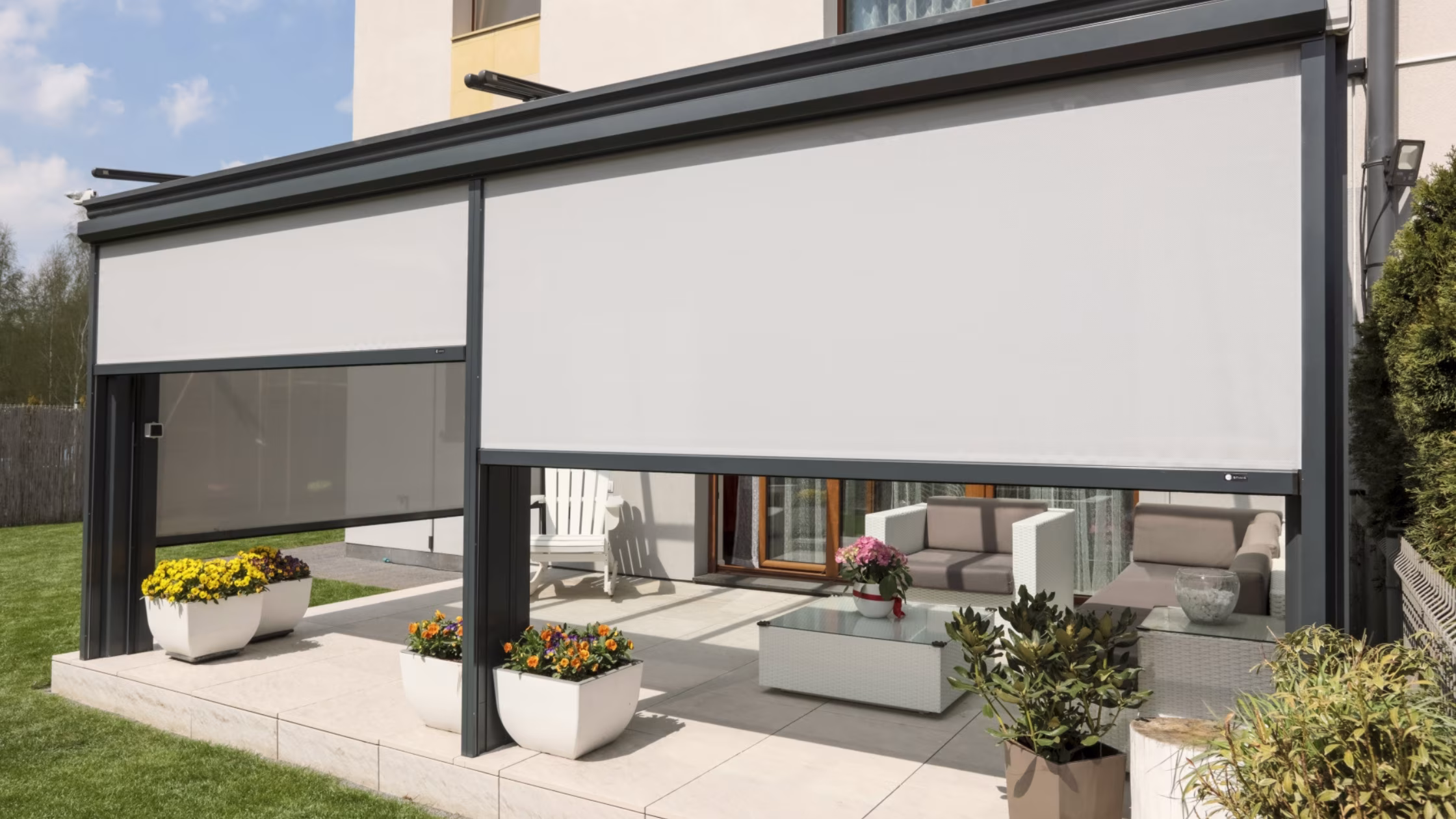 Zip screen blinds integrated into a modern pergola on a Dubai villa terrace, providing sun and wind protection