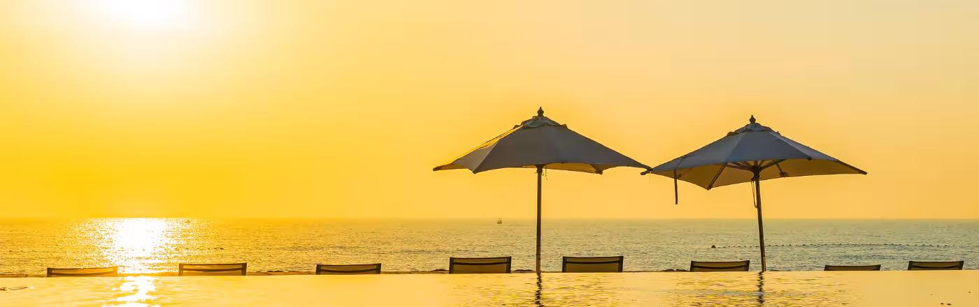 Large cantilever outdoor umbrella installed at a Dubai villa pool area — 360° rotation square canopy with marble stone base