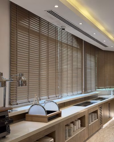 Wooden blinds Dubai — custom 50mm basswood venetian blinds in a modern Dubai apartment