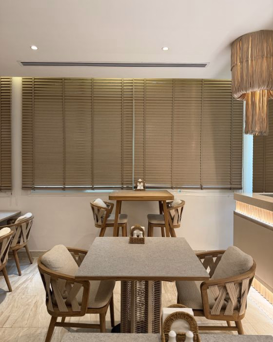 Wooden venetian blinds in a Dubai villa — 50mm Basswood slats tilted for light control